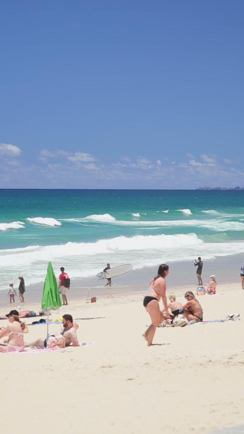 Longboard Along the Shore, Surfers Paradise (Gold Coast stock video)